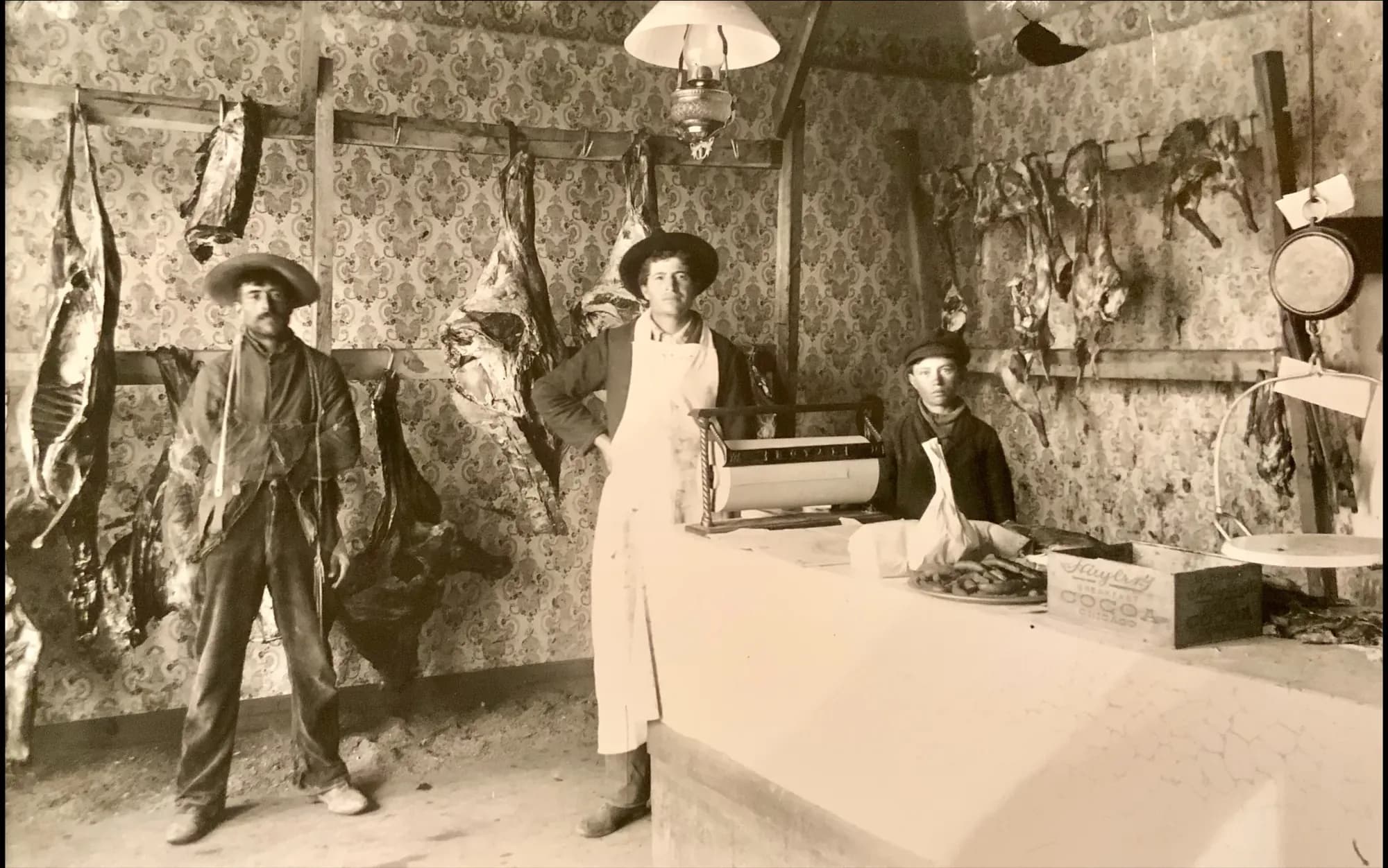 Historic Pacheco butcher shop with three family members behind the counter