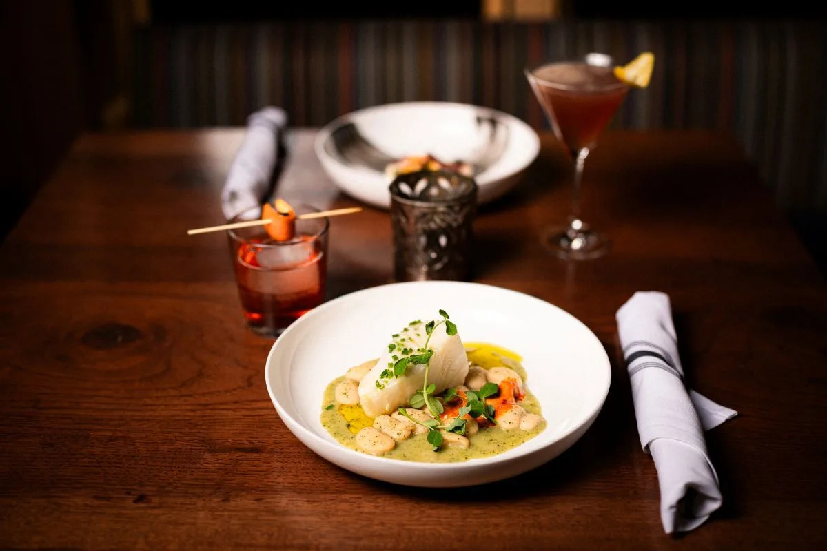 A plated dish and cocktails at 192 at The Blake